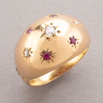 an image of a gold ring with diamonds and rubies on it