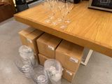 several empty wine glasses are on a table in a store