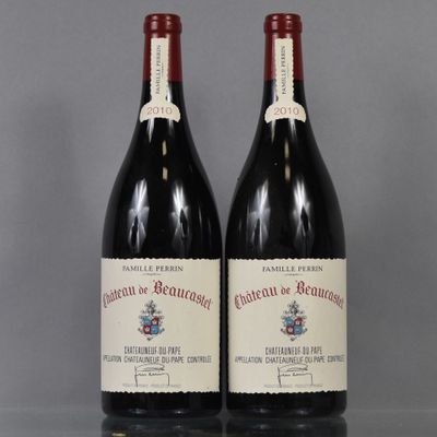 two bottles of red wine sitting on top of a table
