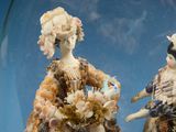 two figurines that are under a glass dome