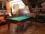 a pool table in the middle of a living room