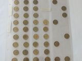 a lot of coins in a clear bag on a table