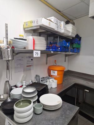 many plates and bowls on the counter in the kitchen