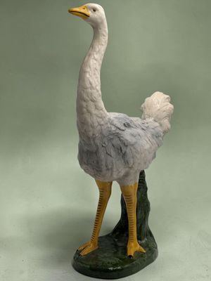 a statue of an ostrich standing on a rock