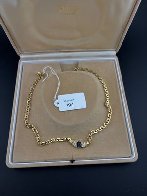 an image of a gold bracelet with a black stone on it