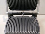 a close up of a black and silver grill on a counter