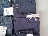 many pairs of pants that are on display in a store