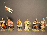 several figurines of knights and knights with flags on a black background