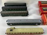 several toy trains are lined up on a white surface
