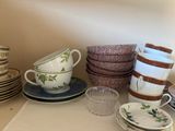 many cups and saucers on the table together