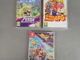 Trois jeux Nintendo Wii sont posés les uns à côté des autres sur une table