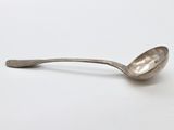 a close up of a spoon on a white surface with a white background