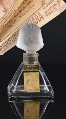 a bottle of perfume with a paper on top of it