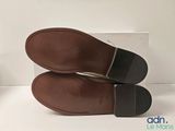 pair of men ' s brown leather slippers on a white surface