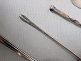 two spoons and a spoon rest on a table