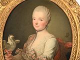 portrait of a lady holding a bird in her right hand