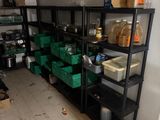 a room with shelves and bins of food in it