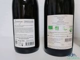 two bottles of wine sitting next to each other on a table