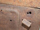 a piece of rust on the side of a rusted piece of metal