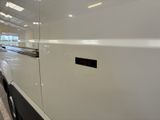 an image of a white van parked in a showroom