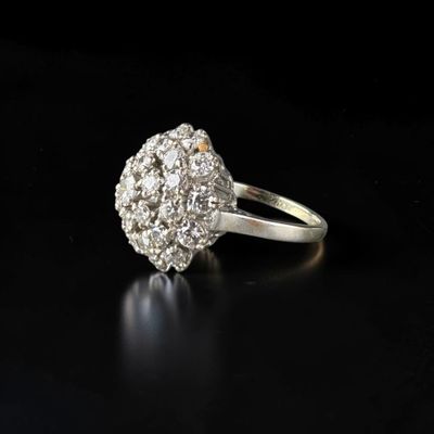 a close up of a diamond ring on a black surface