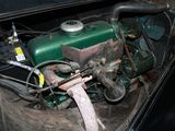 a green engine in the trunk of a black car