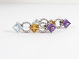 four different colored stones are arranged in a row on a white surface