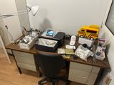 a desk with a computer, printer, and other items on it