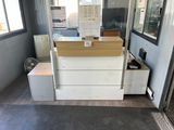 a white counter with a wooden top in a room