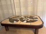 a close up of a coffee table with a mosaic design on it