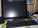 a laptop computer sitting on top of a cluttered desk