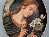 painting of an angel holding a flower in a blue frame