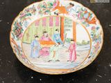 a plate with a painting on it on a table