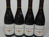 four bottles of wine are lined up on a table