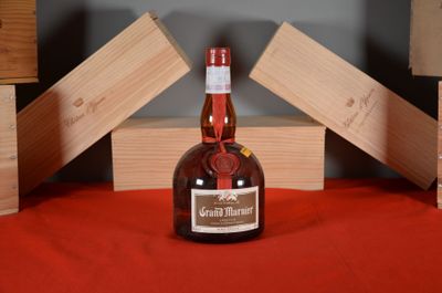 a bottle of liquor sitting on a table next to wooden blocks