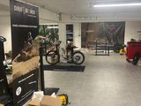 a room with a lot of motorcycles and boxes on the floor