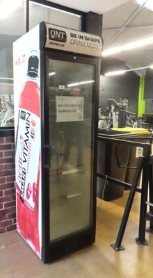 a vending machine with a sign on the front of it