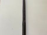 an old baseball bat sitting on top of a table next to a bat