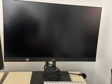 a computer monitor and keyboard on a desk