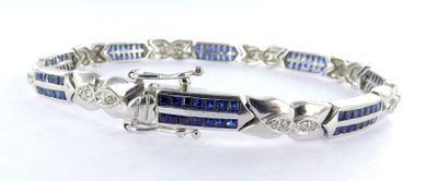 a close up of a bracelet with blue and white stones