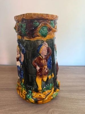 a ceramic mug with a picture of a man and a woman on it