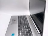 a silver laptop with a blue sticker on the screen