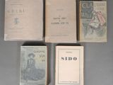 several old books sitting on top of a table next to each other