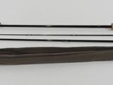 a close up of a pair of fishing rods on a white surface