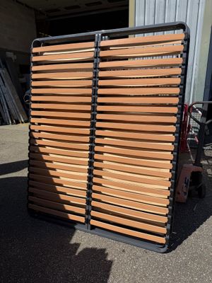 wooden slats stacked on top of each other in front of a building