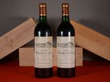 two bottles of wine sitting next to each other on a table