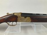a rifle with a wooden barrel and brass plated body