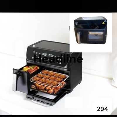 an image of a black air fryer oven with food in it