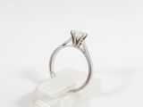 a close up of a ring with a diamond on top of it