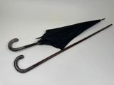 a black umbrella that is sitting on a white table